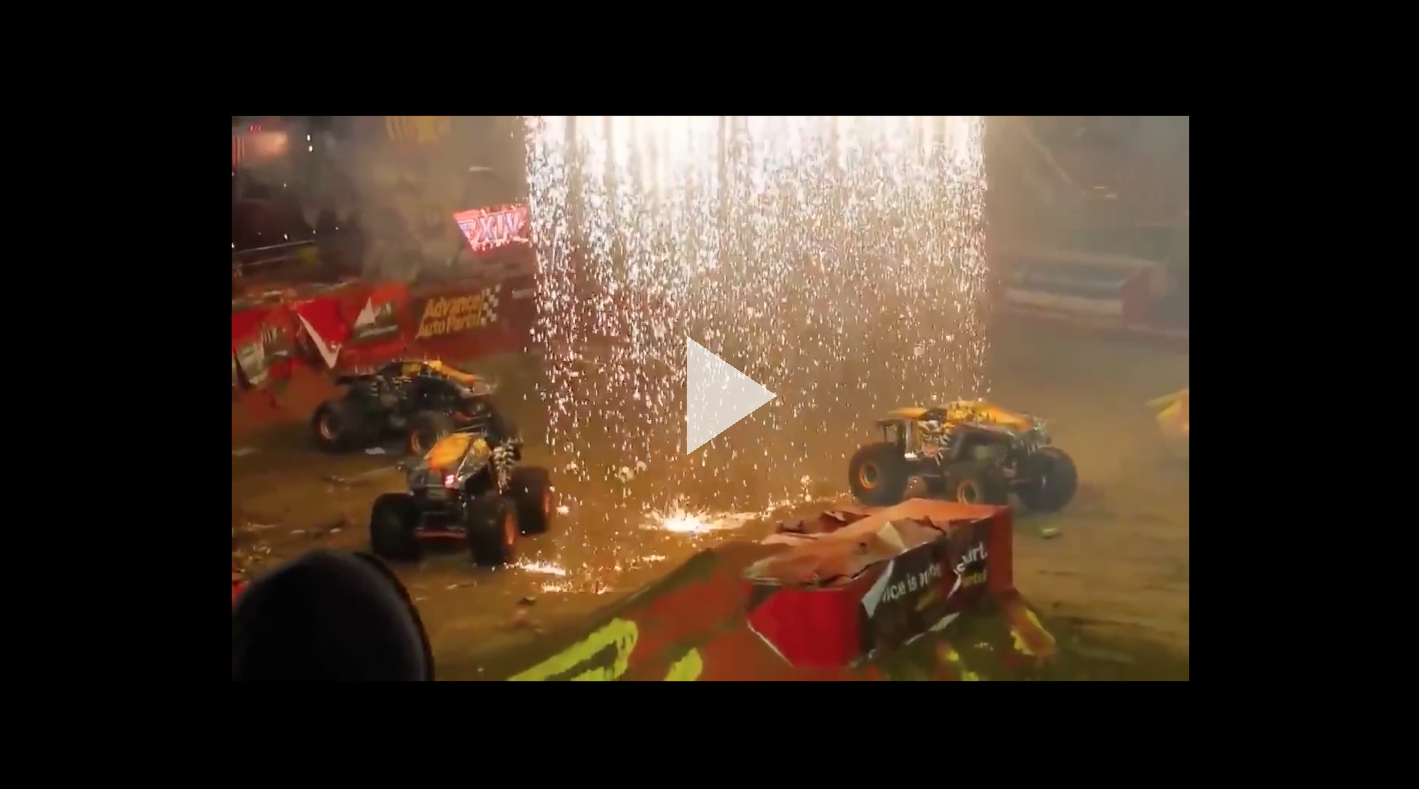 Still from Resonance (video) of monster trucks with sparks raining down on them